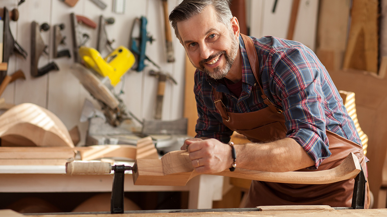 Working With Wood Gives Joy/Carpenter works with a planer in a w